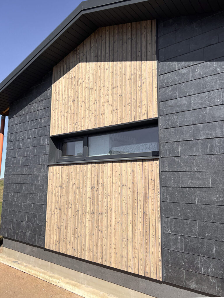 A modern house facade with charred wood siding