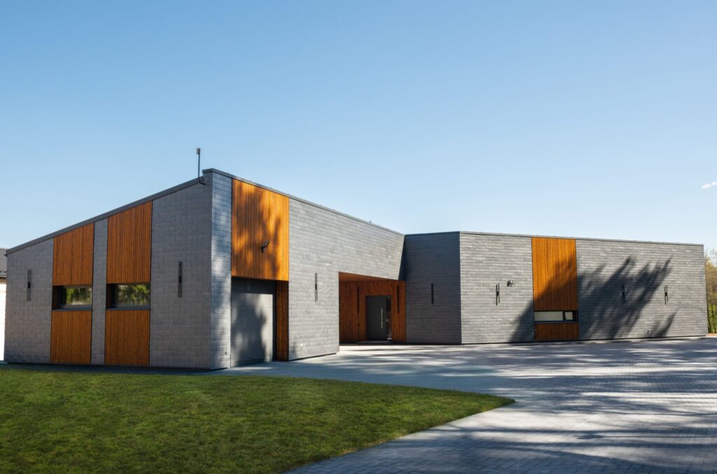 A modern house with a slate stone facade and charred wood accents - contemporary architecture