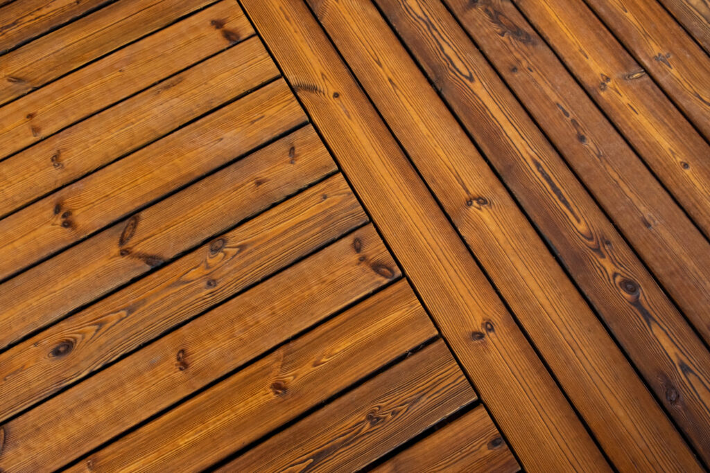 Charred pine decking boards laid diagonally